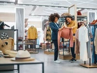 woman helping customer in boutique