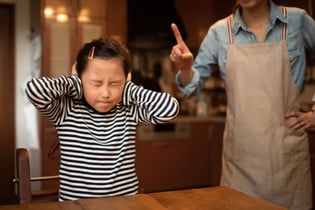 girl with hands over ears