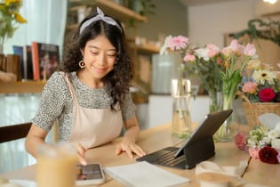 smiling retail store owner working on pricing