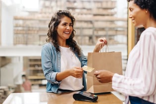 smiling customer purchasing in retail store