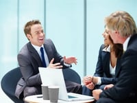 salesman telling story to seated couple