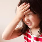 Little girl with hand to head in exasperation